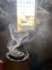 Close-up of smoke emitting from window