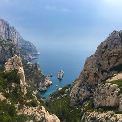 Rock formations by sea against sky