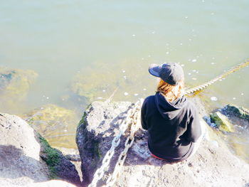 Woman sitting on rock
