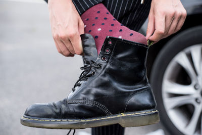 Low section of man holding shoes