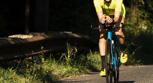 Man riding bicycle on road