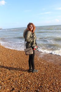 Portrait of woman standing at beach