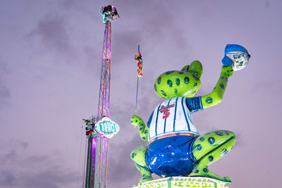 Low angle view of amusement park ride against sky