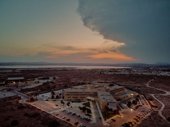 High angle view of city by sea against sky