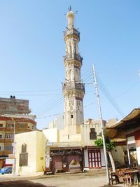 Low angle view of buildings against clear blue sky