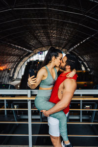 Portrait of young couple in love having a special moment in gym clothes