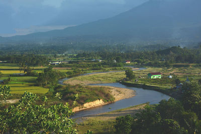 Scenic view of landscape and lake against sky