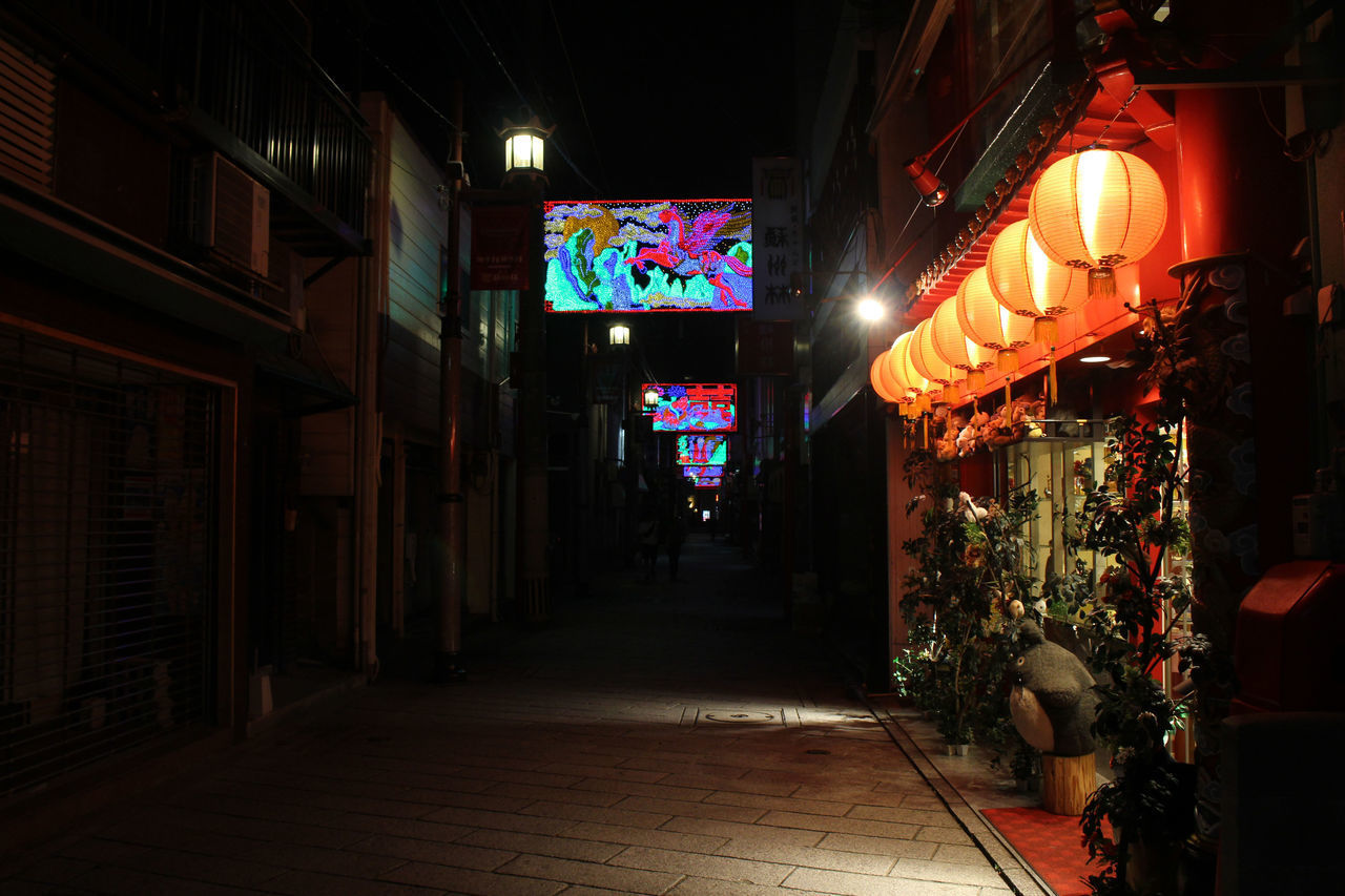 ILLUMINATED LANTERNS HANGING ON FOOTPATH AT NIGHT