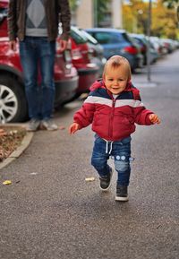 Little boy taking his first steps down the street