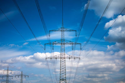 Low angle view of electricity pylon against sky