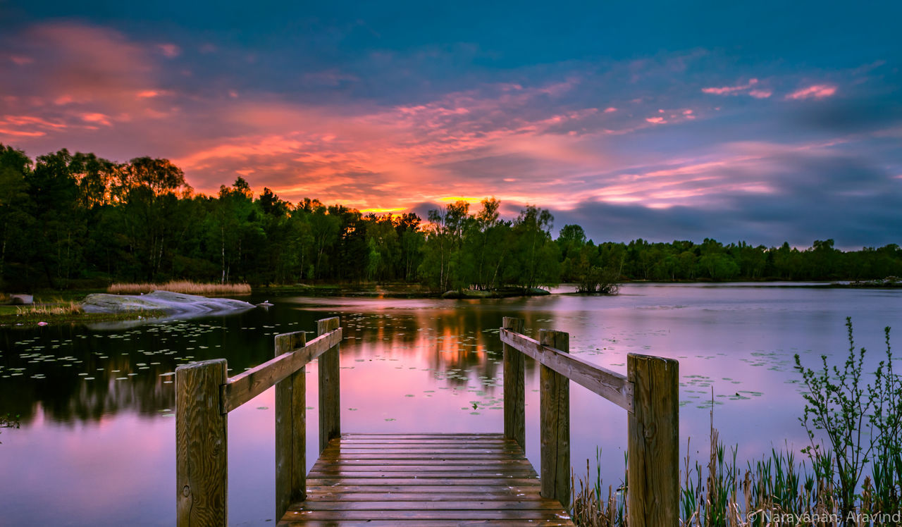 SCENIC VIEW OF LAKE AT SUNSET