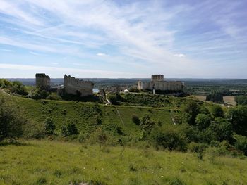 Scenic view of field against cloudy sky