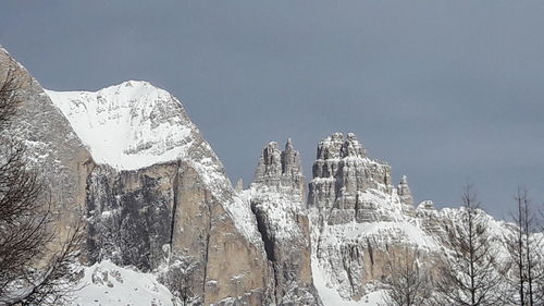 Low angle view of snowcapped mountain against sky