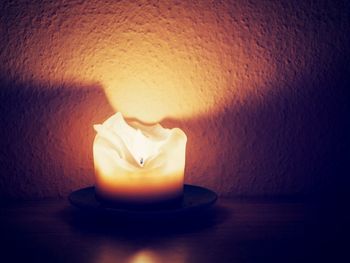 Close-up of illuminated lamp on table