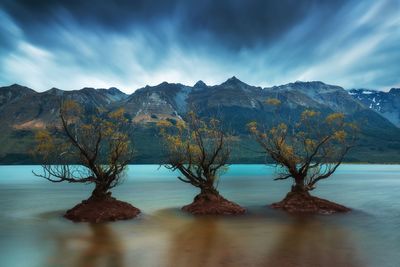 Scenic view of lake and mountains against sky