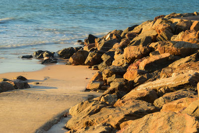 Rocks on beach by sea