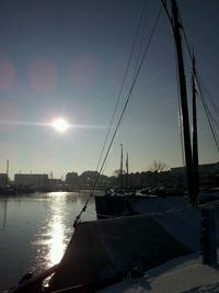 Sailboats moored at harbor