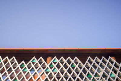 Low angle view of building against clear blue sky