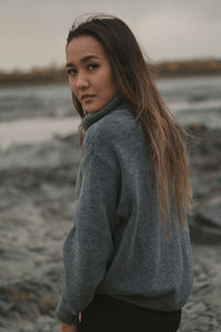 Young woman standing at beach