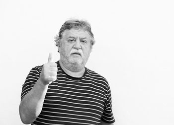 Portrait of man standing against white background