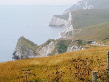 Scenic view of sea and mountains against sky