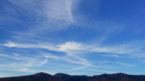 Scenic view of mountains against cloudy sky