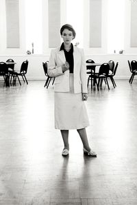 Portrait of young woman standing indoors