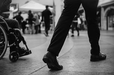 Low section of people walking on street