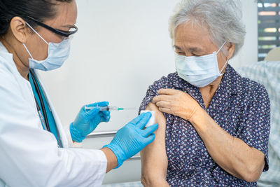 Side view of doctor examining patient in hospital