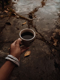 Cropped hand of woman and coffee
