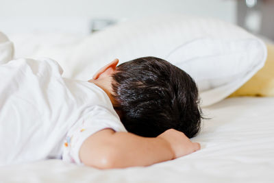 Close-up of boy sleeping on bed