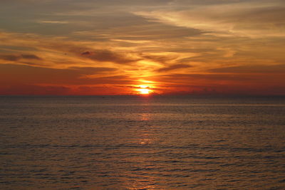 Scenic view of sea against orange sky