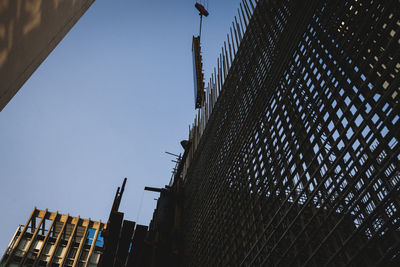 Low angle view of buildings against clear blue sky