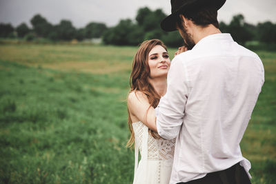 Young couple standing on field