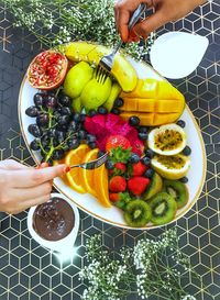 High angle view of woman holding fruits