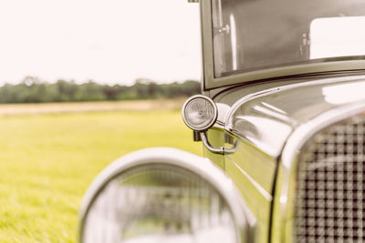 Close-up of vintage car on field