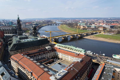 High angle view of river amidst buildings in city against sky