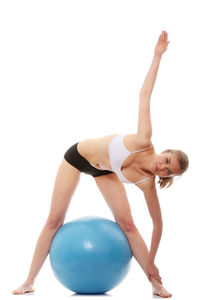 Midsection of woman with arms raised against white background