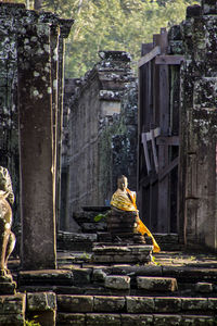 Buddha statue on staircase by building