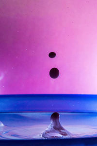 Close-up of pink ball on blue surface