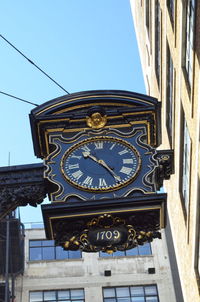 Low angle view of clock tower against sky