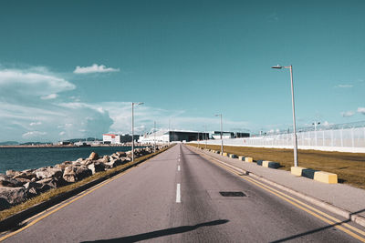 Road by street against sky