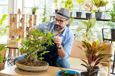 Man wearing hat gardening at home