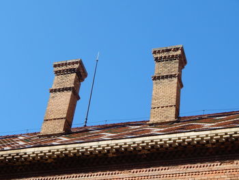 Low angle view of old building against blue sky