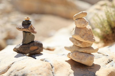 Pyramid stones balance on the sand rock. the object is in focus, the background is blurred