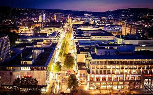 Aerial view of city lit up at night