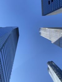 Low angle view of modern buildings against clear blue sky