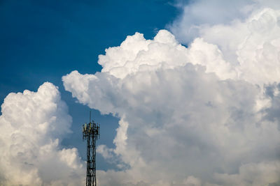 White heap cloud back on signal pole on blue sky