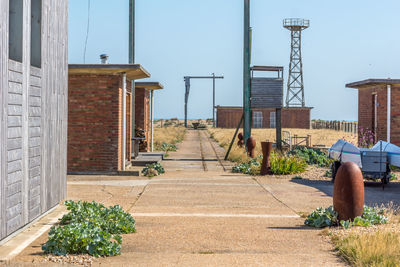 Empty walkway by houses