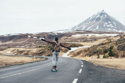 Man skateboarding on highway